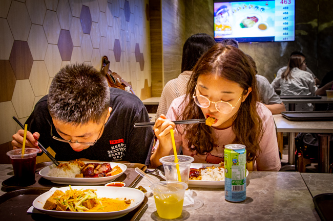 People eating chicken rice